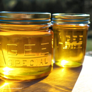 two yellow jars of liquid ghee