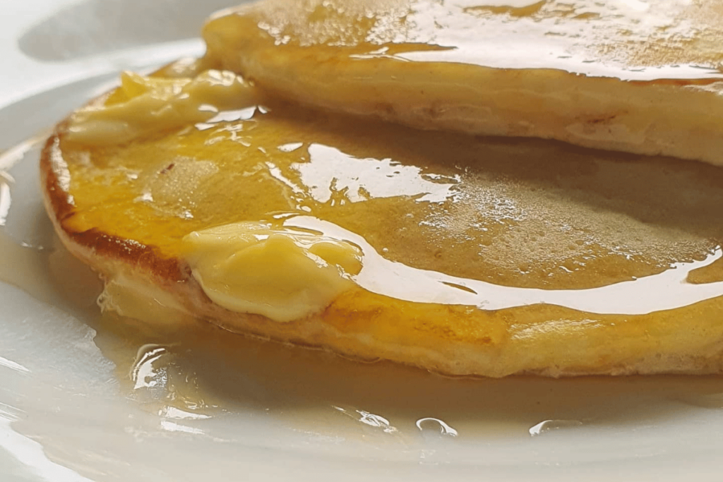 Two fluffy pancakes with melting butter ontop