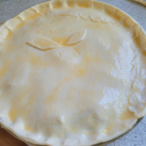 finished pie with egg wash over the flaky pastry