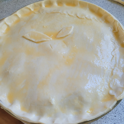 finished pie with egg wash over the flaky pastry