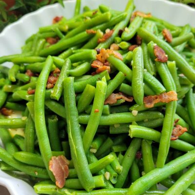 a plate of green beans with crispy bacon