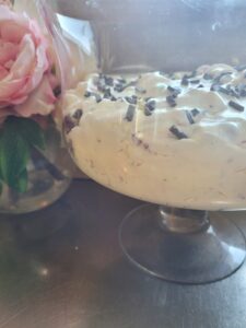 glass bowl with ambrosia dessert in it with chocolate chips on top