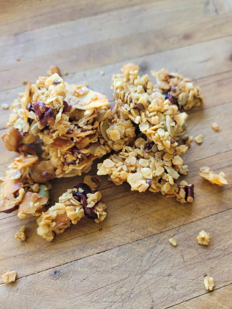 clusters of homemade granola on a wooden chopping board