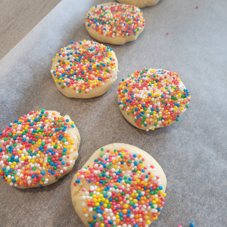 biscuits ready to be baked, they are topped with sprinkles