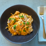 slow cooker spaghetti pork meatballs in a black bowl