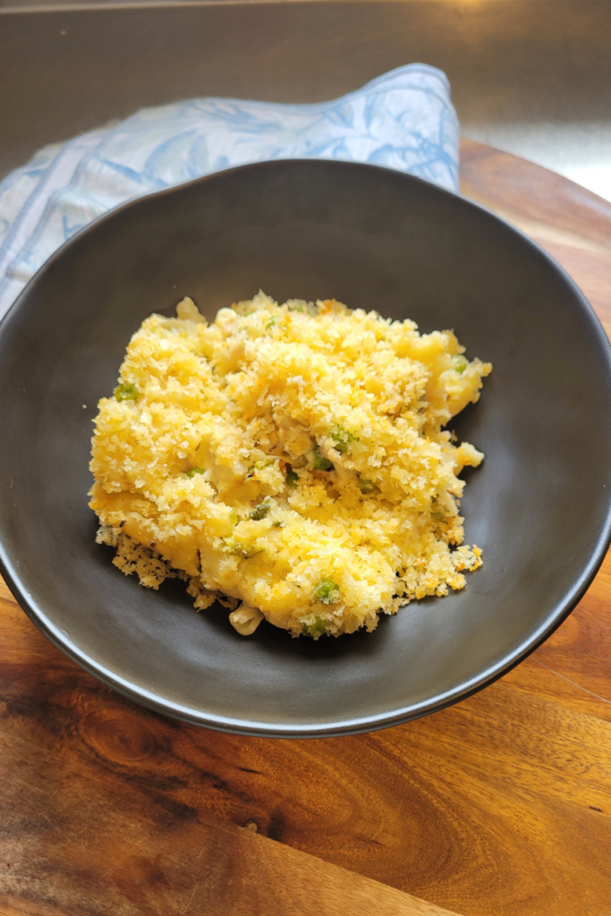 tuna and broccoli boxed mac and cheese with a crispy topping in a black bowl