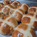 a dozen fruit hot cross buns with a sugar glaze and white crosses on top