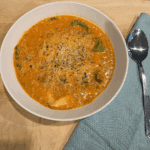 a bowl of creamy tomato tortellini soup