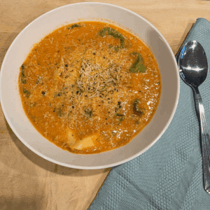 a bowl of creamy tomato tortellini soup