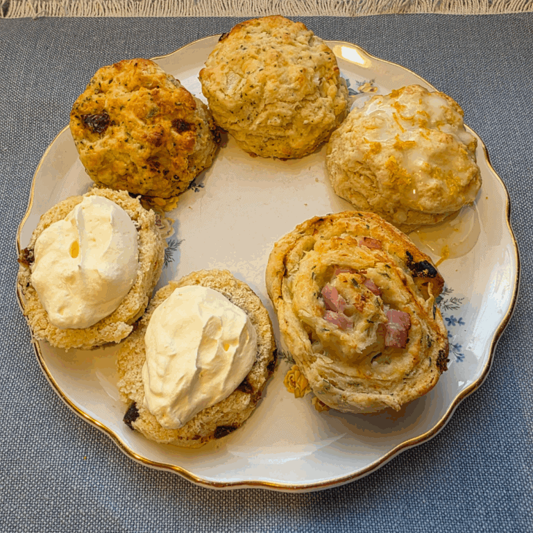 Five flavours of scones on a china plate.
