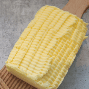 Freshly made butter sitting on wooden butter paddles