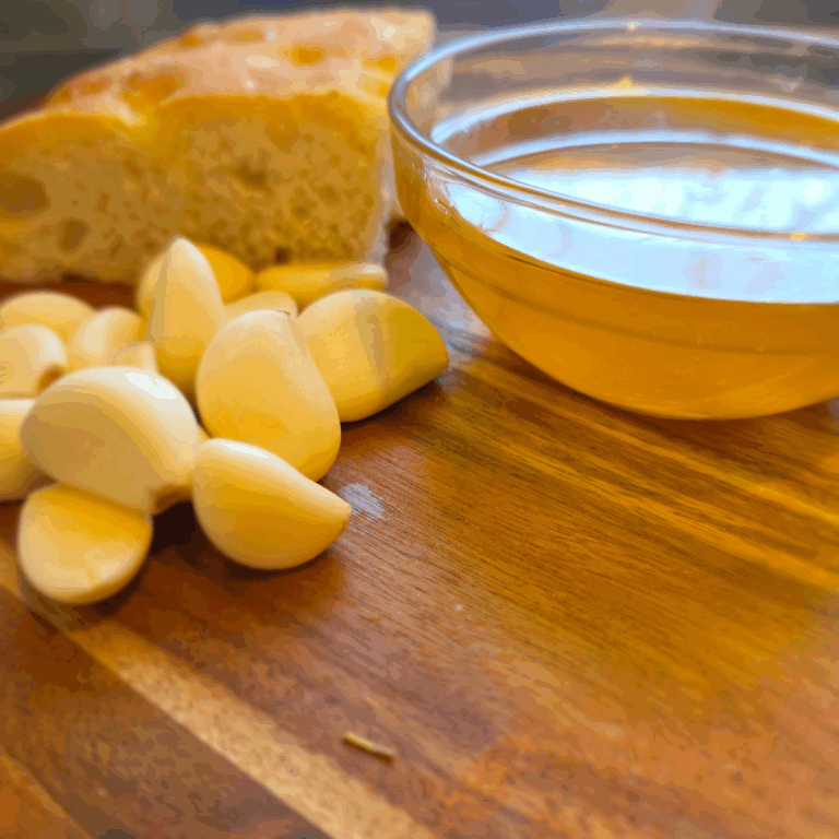 homemade garlic oil in a jar with fresh garlic cloves