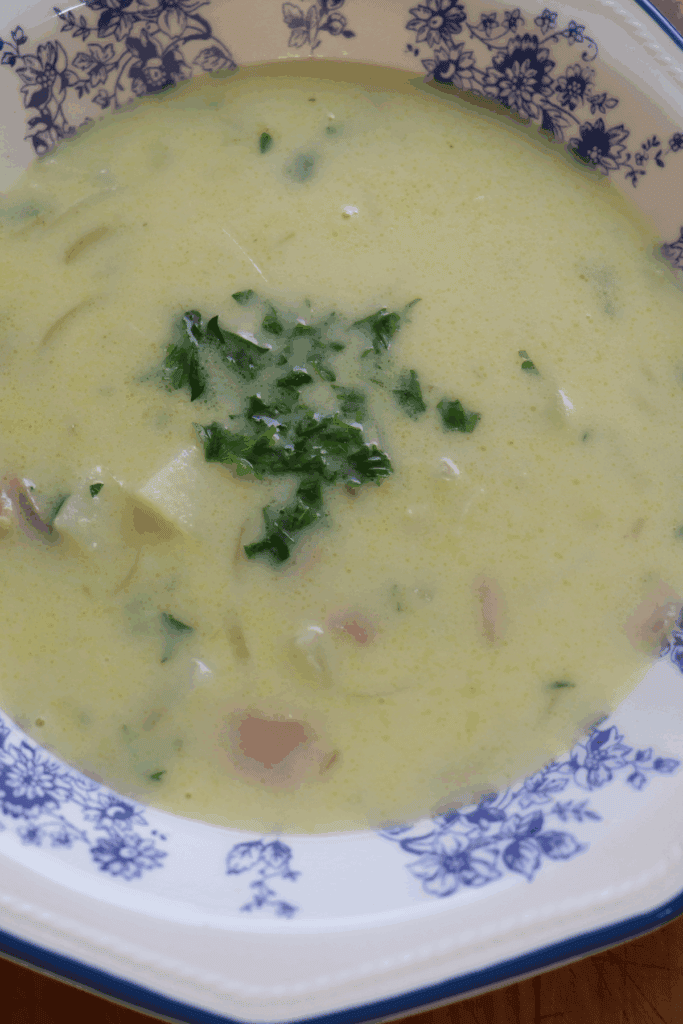 blue china bowl with a hearty potato, bacon and onion soup