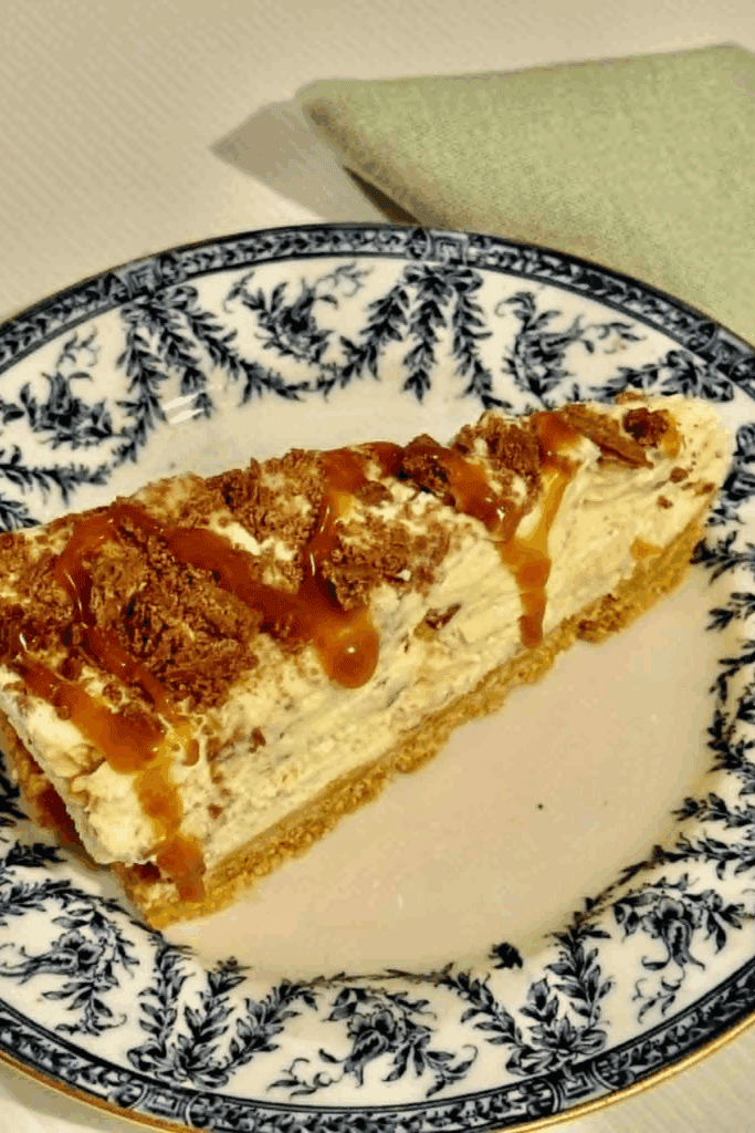 Close-up of sliced Crunchie cheesecake showing crushed honeycomb pieces and buttery biscuit base.