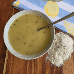 a bowl of chicken gravy and my easy homemade chicken gravy powder. Sitting on a wooden board
