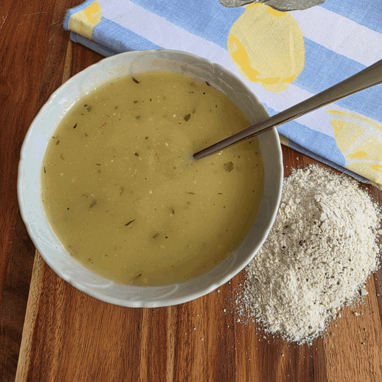 a bowl of chicken gravy and my easy homemade chicken gravy powder. Sitting on a wooden board