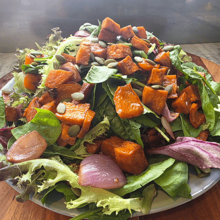 “Colourful roasted vegetable salad with greens and balsamic dressing.”