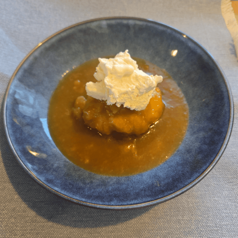 Soft dumplings cooked in golden syrup sauce