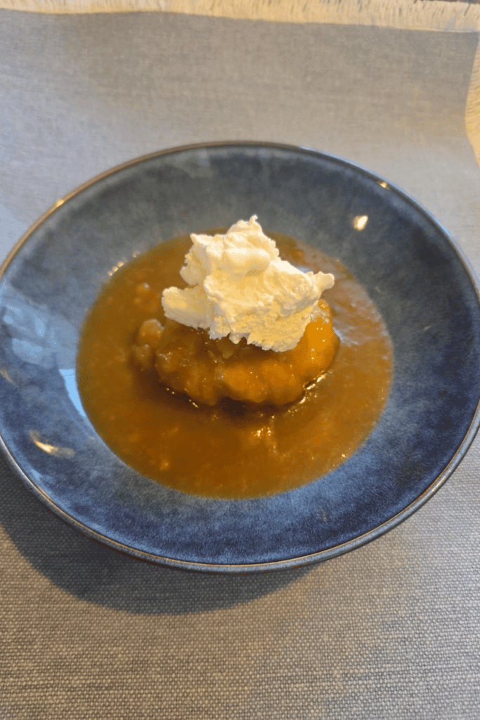 Soft dumplings cooked in golden syrup sauce