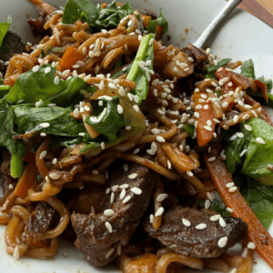Beef stir fry with egg noodles, mixed vegetables, cashews and sesame seeds