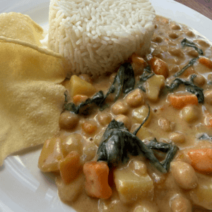 Creamy Thai red chickpea curry with vegetables served alongside white rice