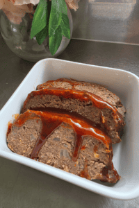 Juicy homemade beef and sausage meatloaf with a sticky tomato sauce topping