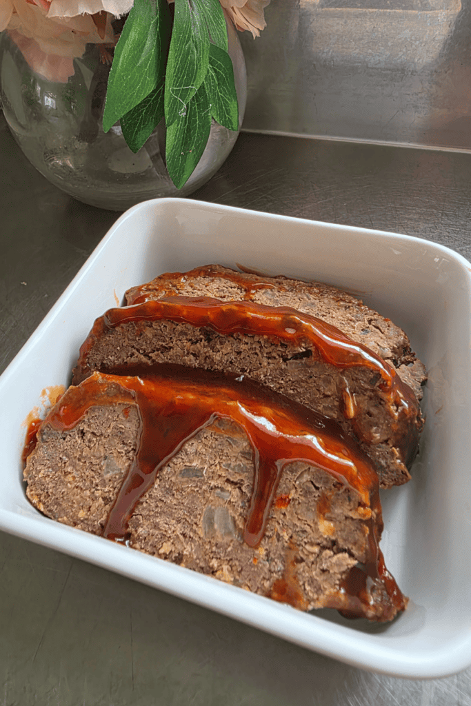 Juicy homemade beef and sausage meatloaf with a sticky tomato sauce topping