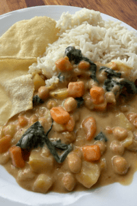 Creamy Thai red chickpea curry with vegetables served alongside white rice