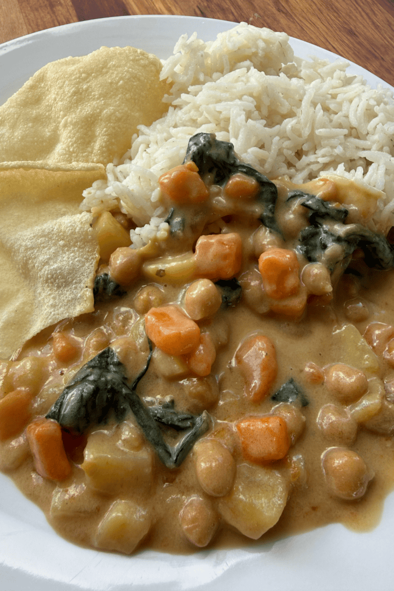 Creamy Thai red chickpea curry with vegetables served alongside white rice