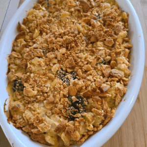Chicken broccoli pasta casserole topped with cheese and buttery crackers