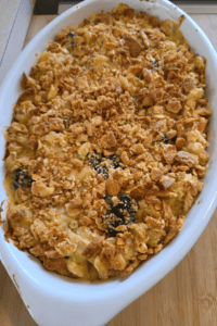 Chicken broccoli pasta casserole topped with cheese and buttery crackers