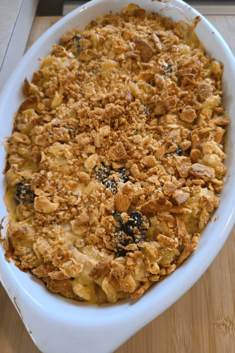 Chicken broccoli pasta casserole topped with cheese and buttery crackers