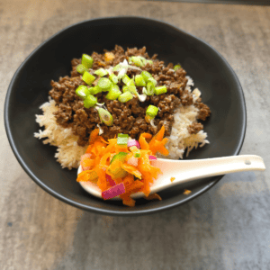 Sticky beef rice bowls topped with quick pickled vegetables