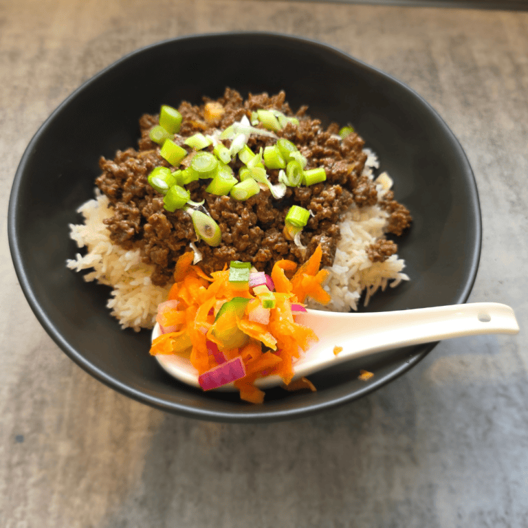 Sticky beef rice bowls topped with quick pickled vegetables
