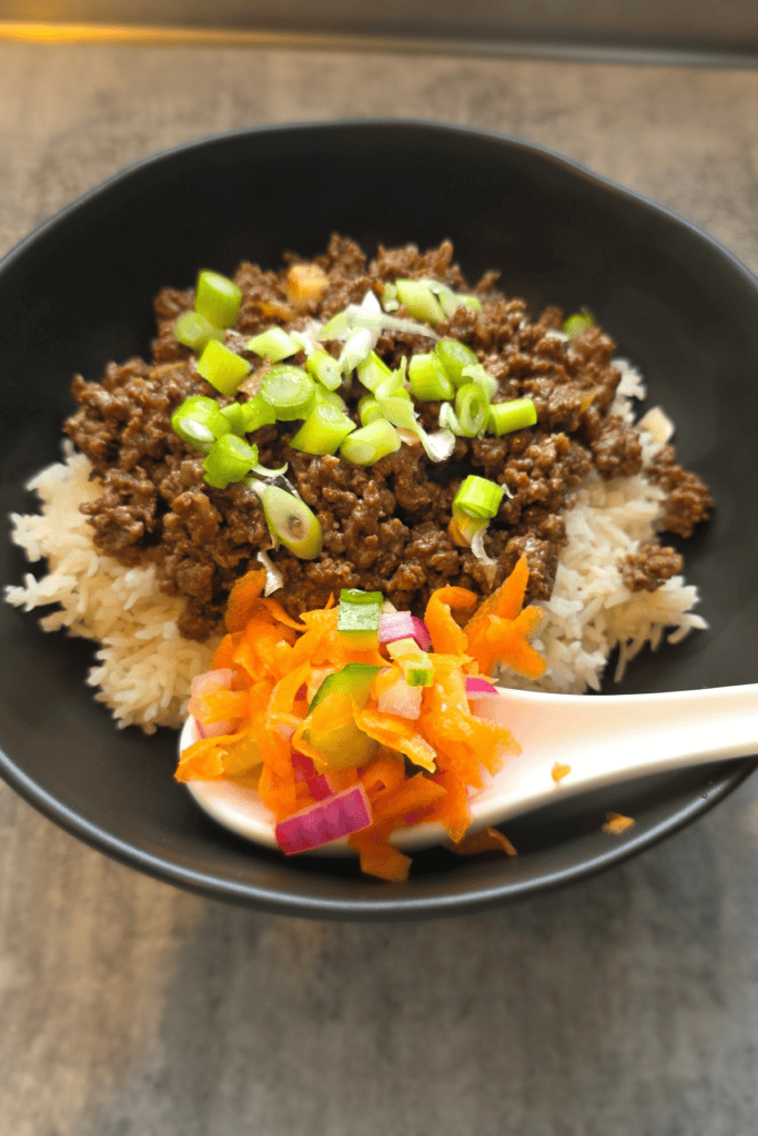 Sticky beef rice bowls topped with quick pickled vegetables